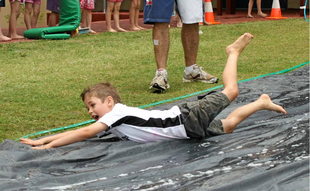 Jack Benz goes head-first down the slip n’ slide. Jack Benz goes head-first down the slip n’ slide.